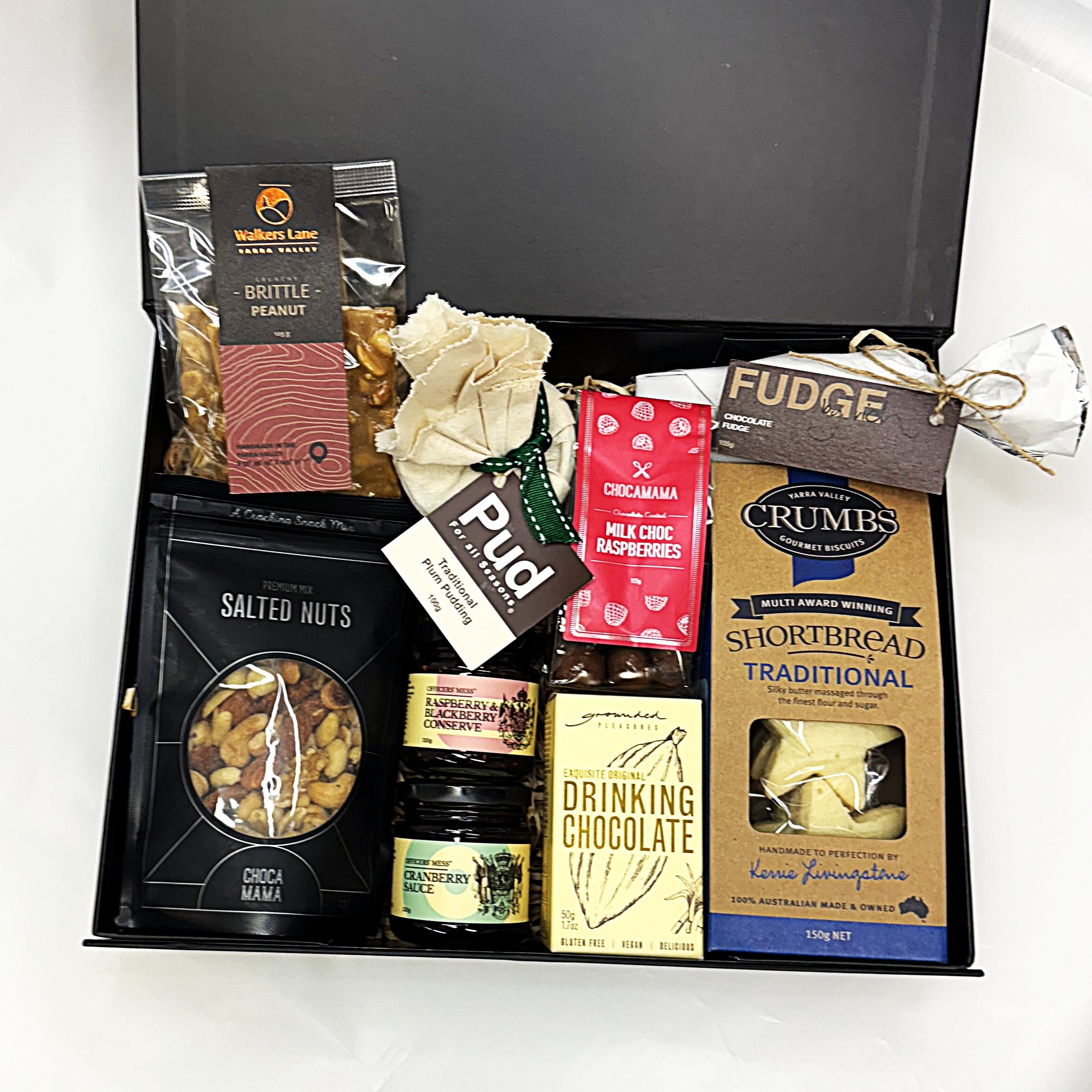 Gourmet Christmas gift box with various treats including fudge, shortbread, and drinking chocolate.